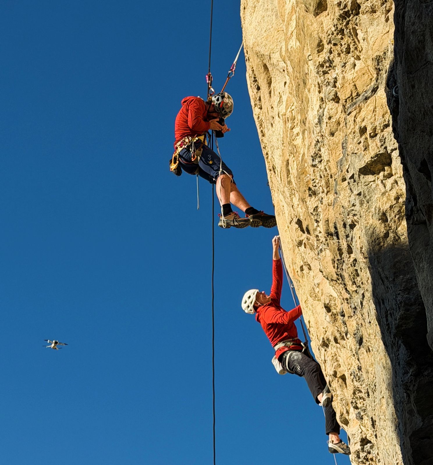 Photographer on the ropes above a climber